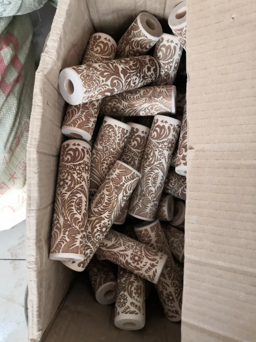 Natural wooden rolling pin with Christmas embossing patterns, 45 cm length, on a light background
