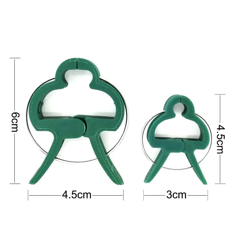 Green plastic and zinc plant fixing clips, large and small sizes, for climbing vegetable support.