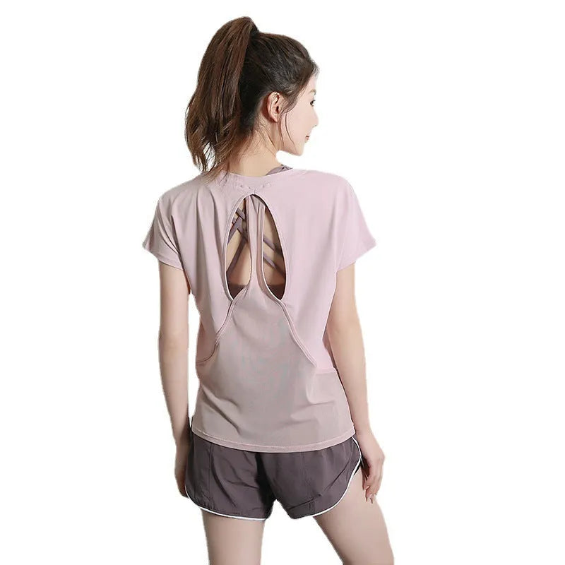 Women's pink short sleeve polyester sports t-shirt for running and fitness.