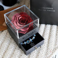 Eternal flower rose jewelry box with preserved roses and carnations on a table