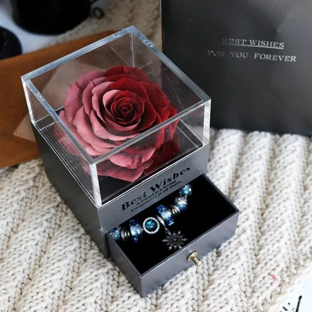 Eternal flower rose jewelry box with preserved roses and carnations on a table