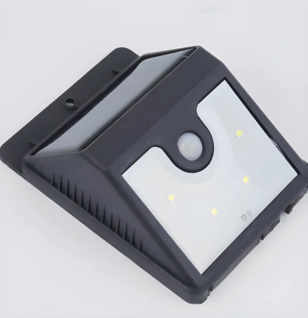 Grey outdoor solar security light with four LED bulbs and a motion sensor mounted on a wall