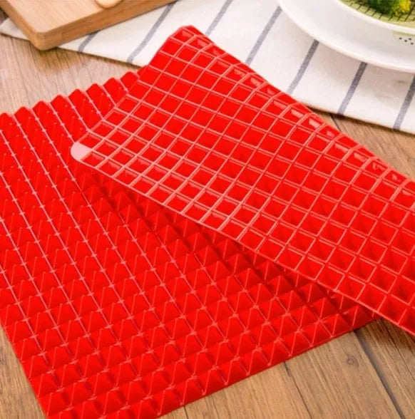 Red non-stick silicone pyramid cooking mat on a baking tray, showing grid pattern and 39.5 cm size