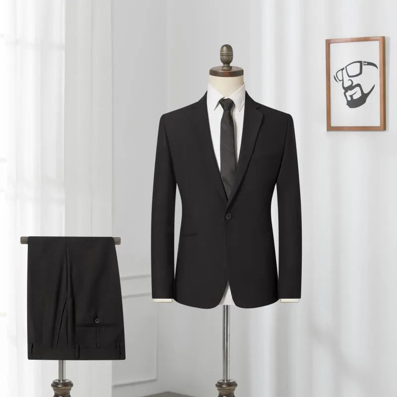 Men's black slim-fit one-button business suit with flat collar and rear slit on a hanger.