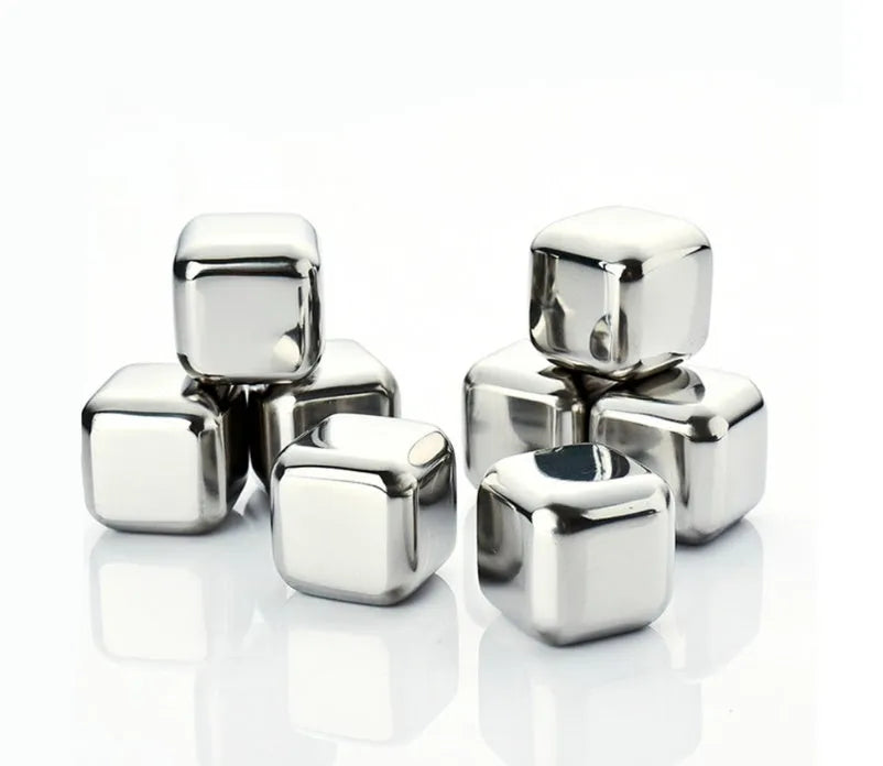 Set of 8 stainless steel ice cubes in square and ball shapes with plastic storage box and tong on a wooden surface