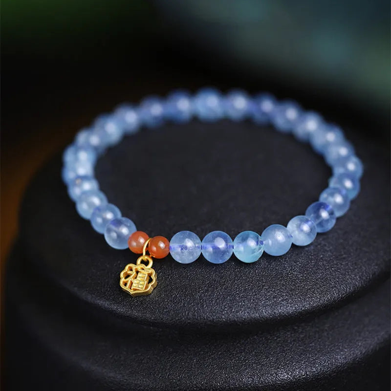 Natural ice translucent 8mm round crystal bead bracelet with sequin accents on display