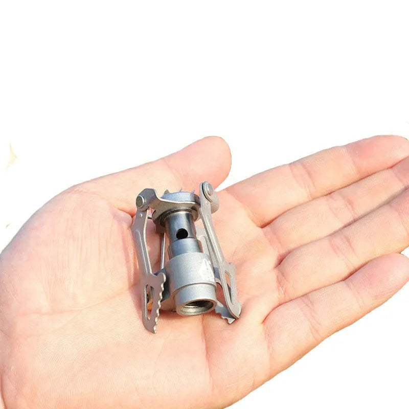 Portable one-piece propane gas camping stove for outdoor cooking.
