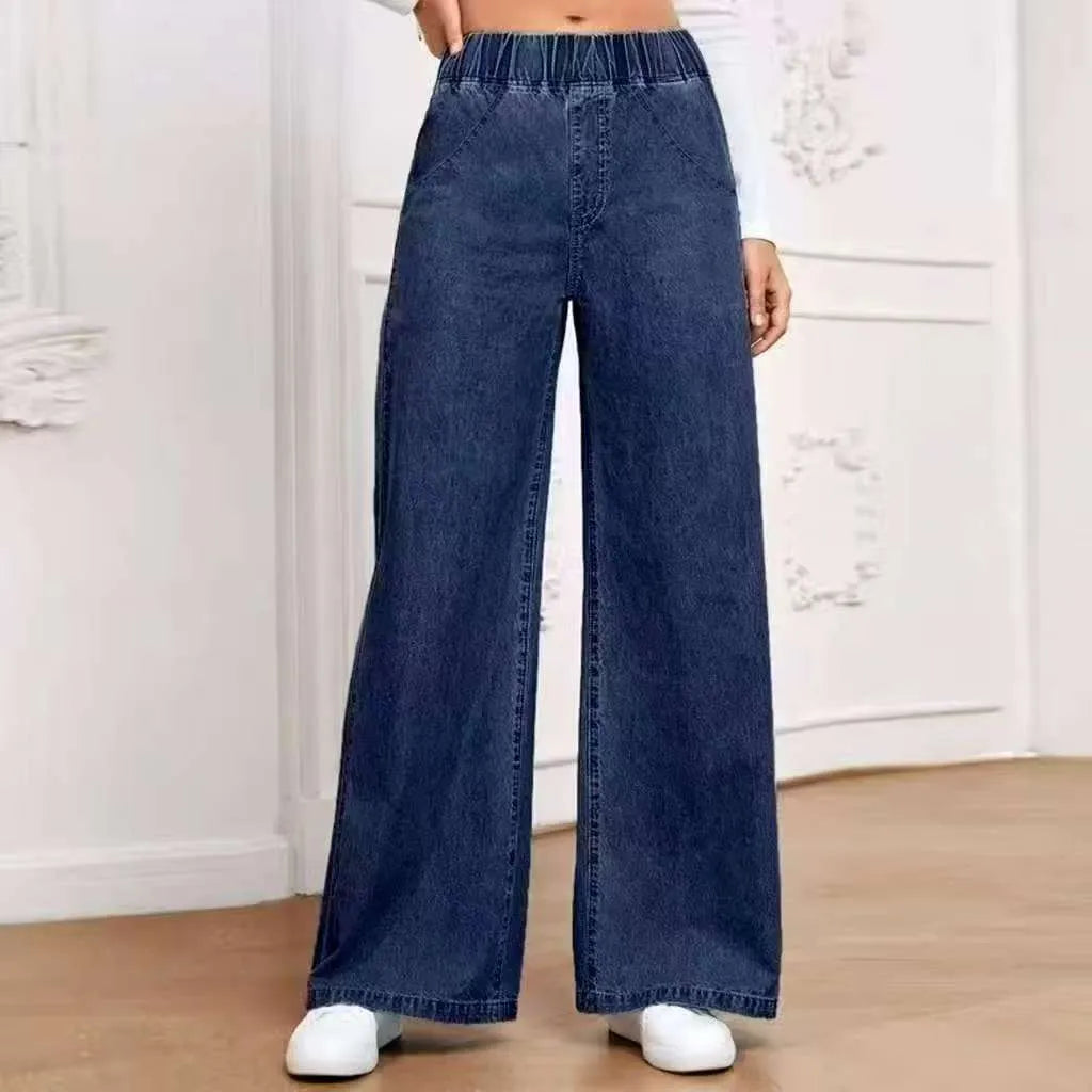 Light blue washed wide-leg denim jeans with straight cut and mid-rise waist on hanger