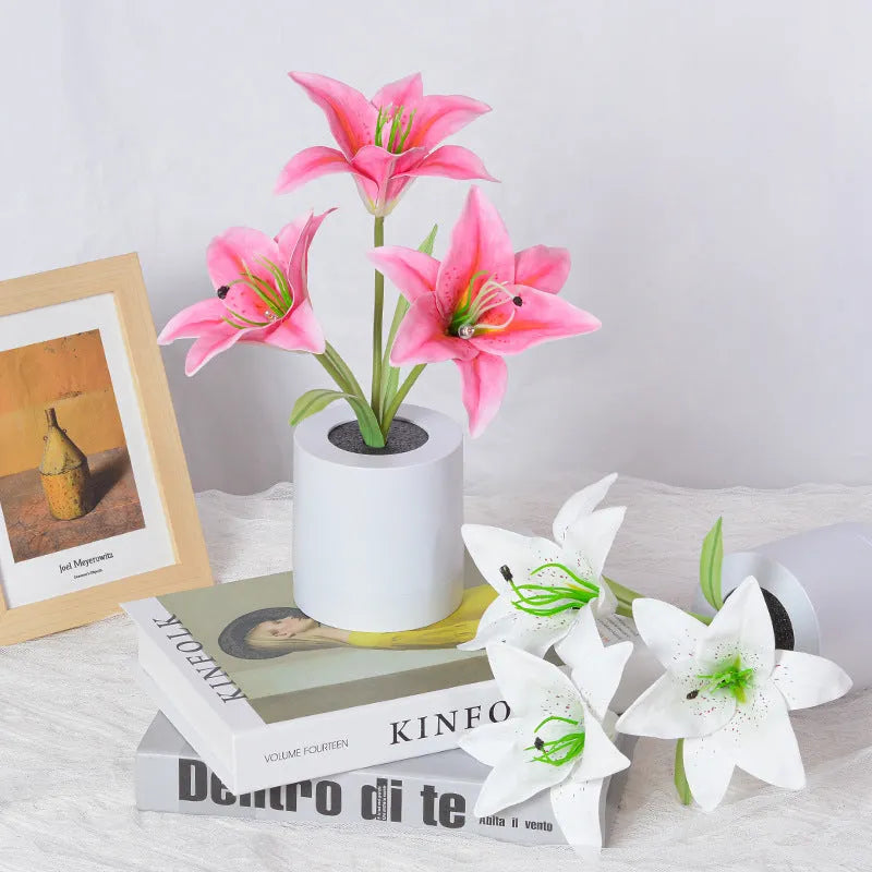 Rechargeable LED lily flower pot lamp in lily-pink colour, flower shape, on tabletop