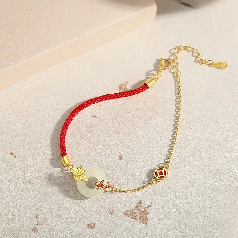 Gold 925 silver koi peace buckle bracelet with red rope on white background