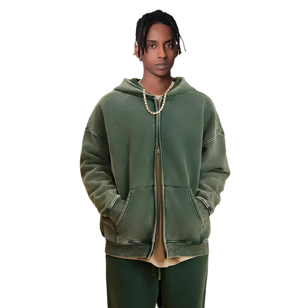 Man wearing a vintage washed dark green hooded cardigan with a double zipper and fleece lining.