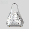 Hollow carved PU leather tote bag in apricot colour with three shoulder straps, horizontal square shape