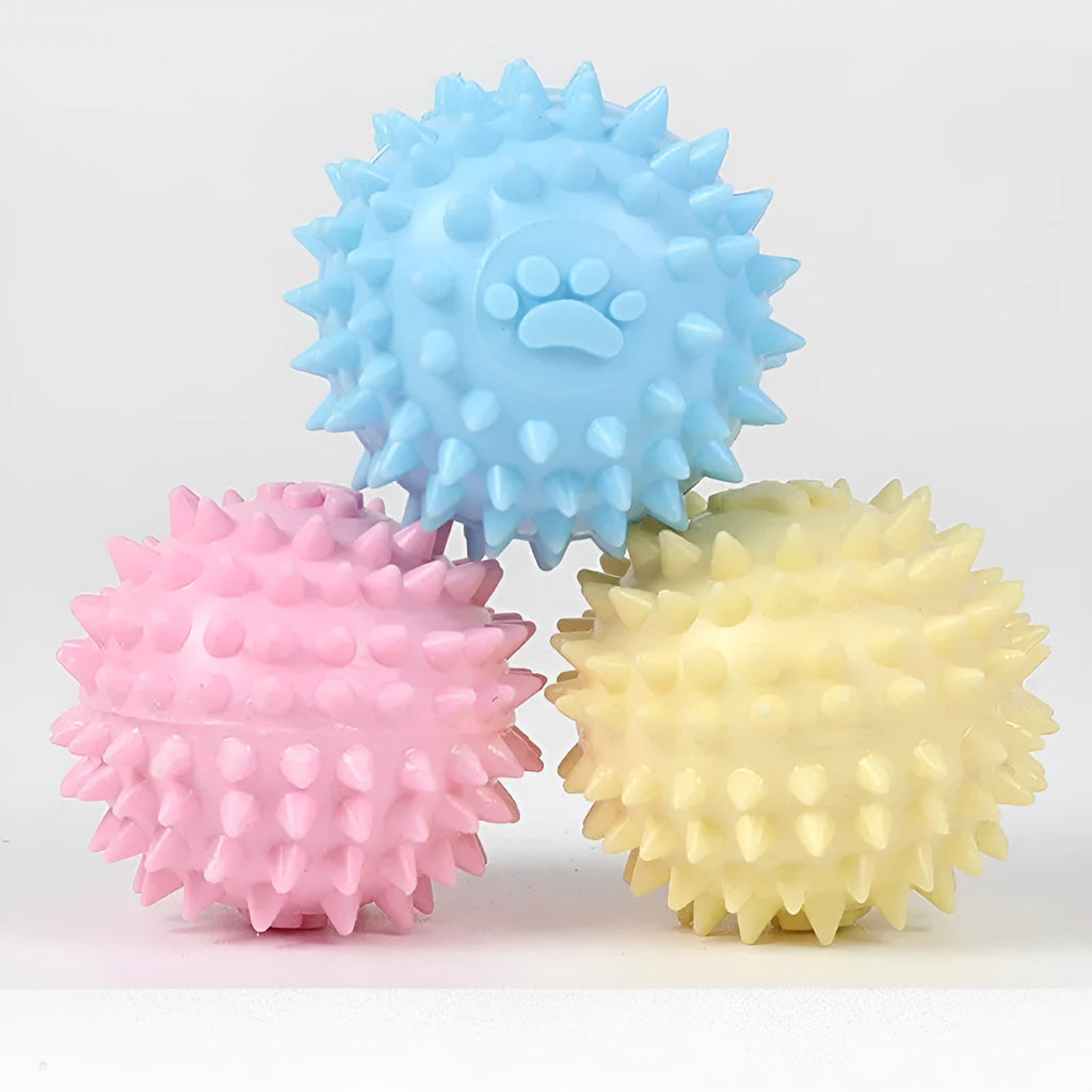 Close-up of 6cm TPR rubber dog chewing toy ball with footprint pattern in blue pink or yellow for tooth cleaning