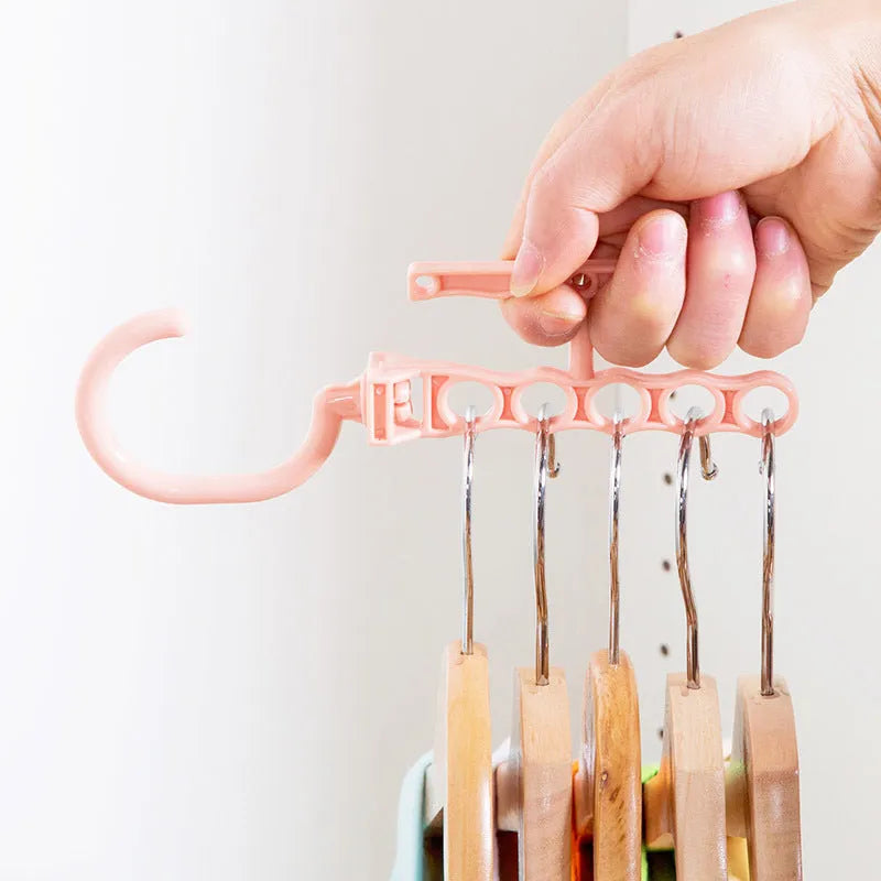 Blue revolving magic hanger with five branches and a handle for wardrobe organisation.