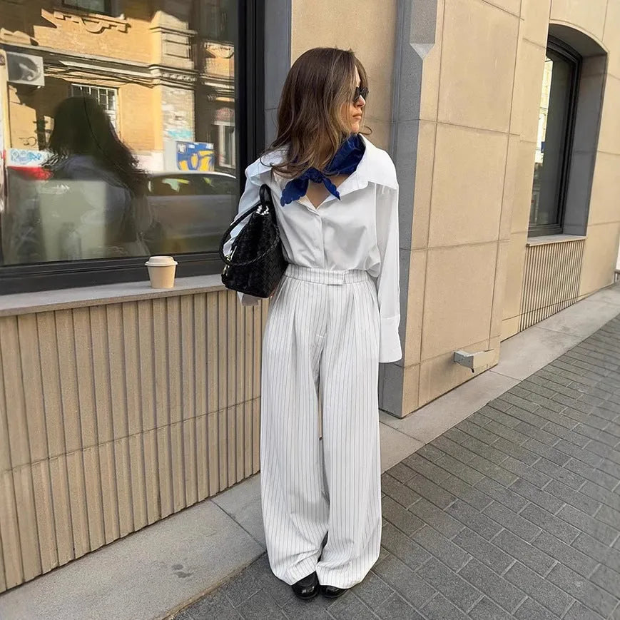 White striped wide-leg casual trousers with zipper closure on mannequin