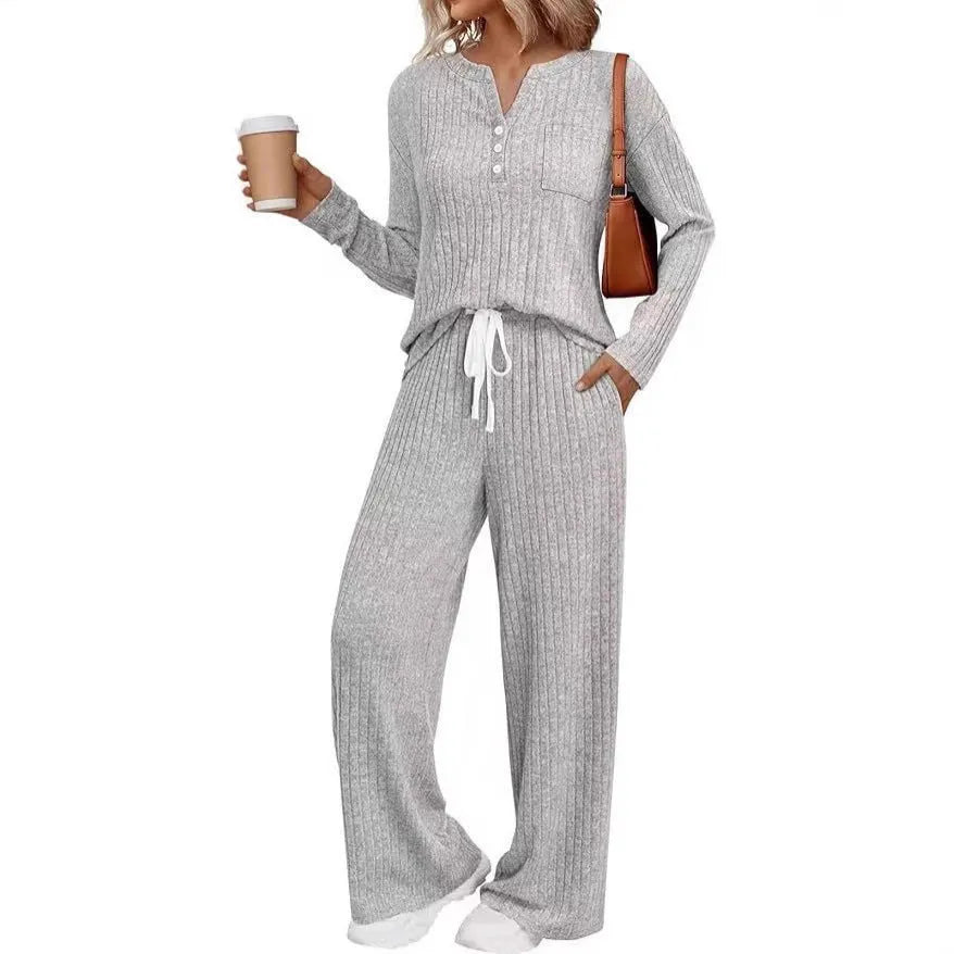 Women's knitted long coat and trouser set in a stripe pattern with V-neck and lace-up detail.
