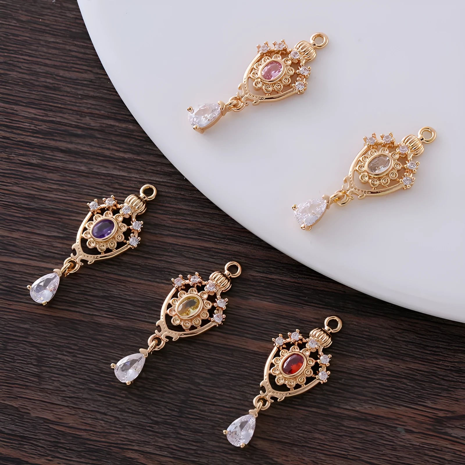 Silver tone crown motif hollow water drop copper pendant in five colours, measuring 12mm by 23mm.