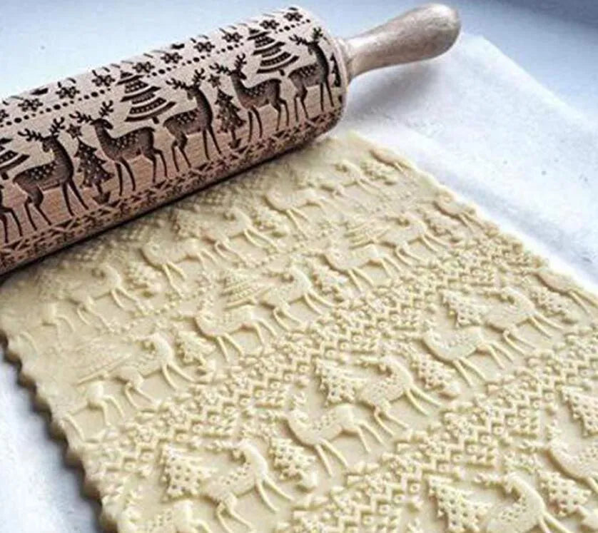 Natural wooden rolling pin with Christmas embossing patterns, 45 cm length, on a light background