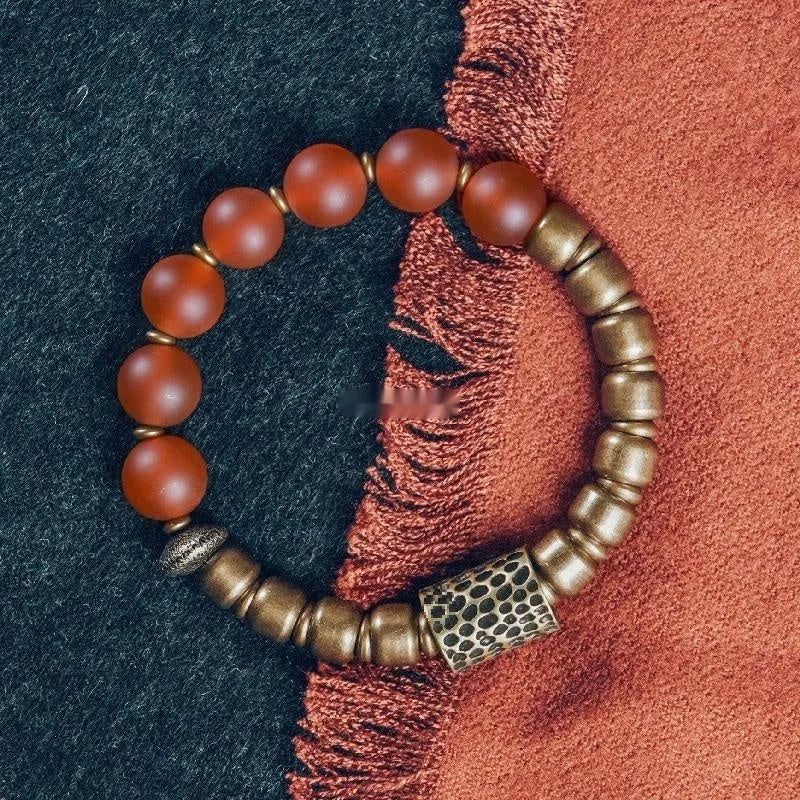 Retro ethnic style natural crystal and agate beaded couples bracelet in red agate on neutral background