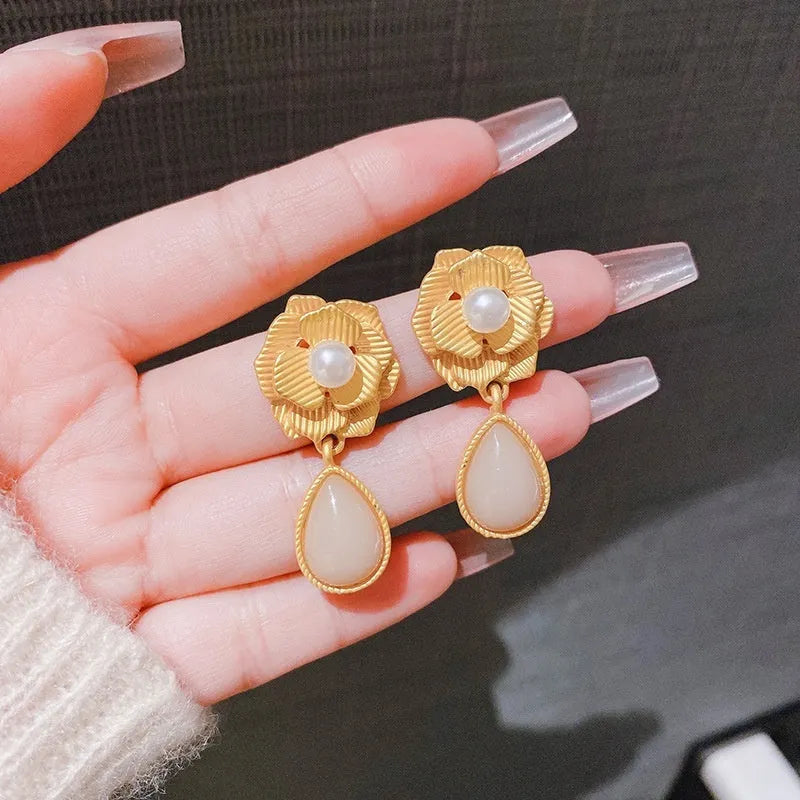 Gold electroplated alloy stud earrings with needle rose pearl design, ice flower motif, and opal stone accent