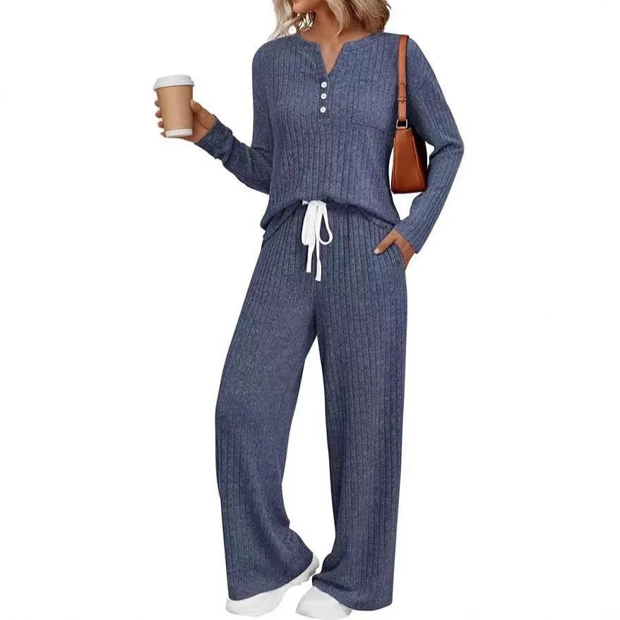 Women's knitted long coat and trouser set in a stripe pattern with V-neck and lace-up detail.