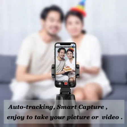 Black smartphone automatic shooting selfie stick with 360° face tracking on three-foot bracket showing phone holder and rotation mechanism