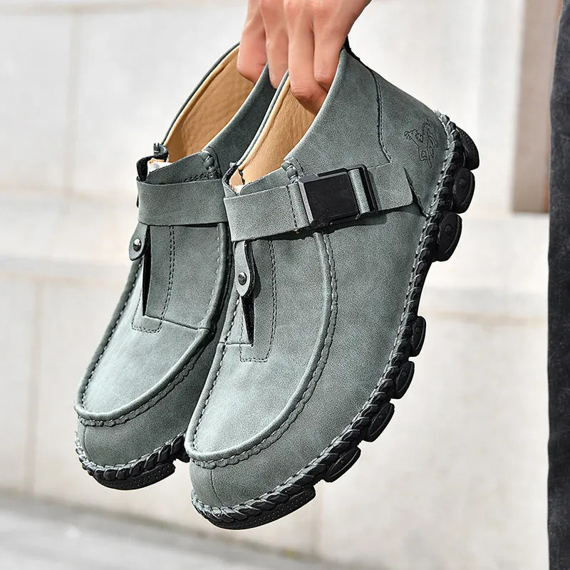 Handmade brown men's casual slip-on shoes with flat heel and sewn sole.
