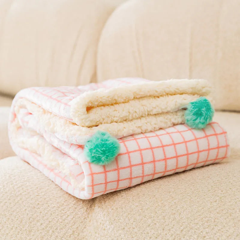 Thickened coral fleece dog blanket in blue on a sofa, size L 70x50cm