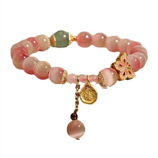 Pink opal butterfly women's bracelet with electroplated finish, Chinese style, on display