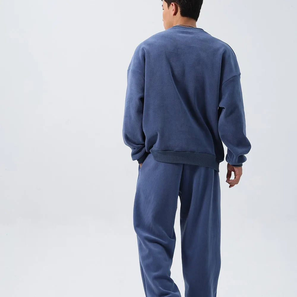 Men's loose fit polar fleece sports suit in winter colours, showing coat and trousers.