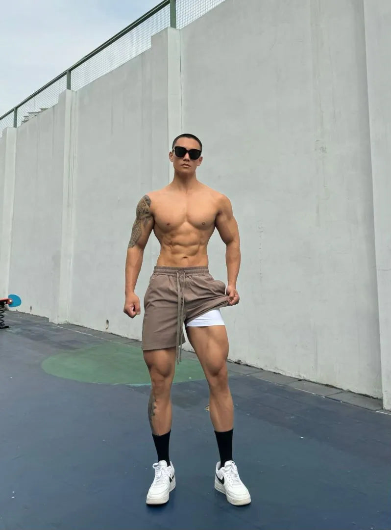 Men's ice silk quick-drying shorts in black, showing double-layer casual design