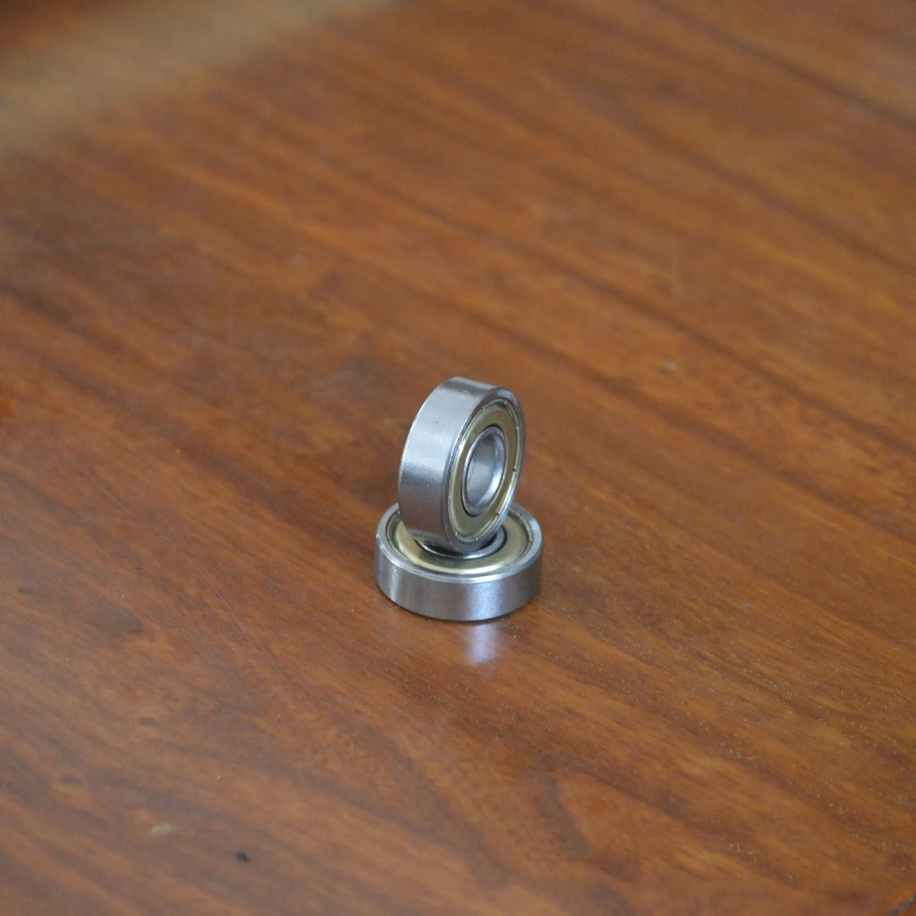 Carbon steel bearing 6000zz 10x26x8mm with iron retainer on white background