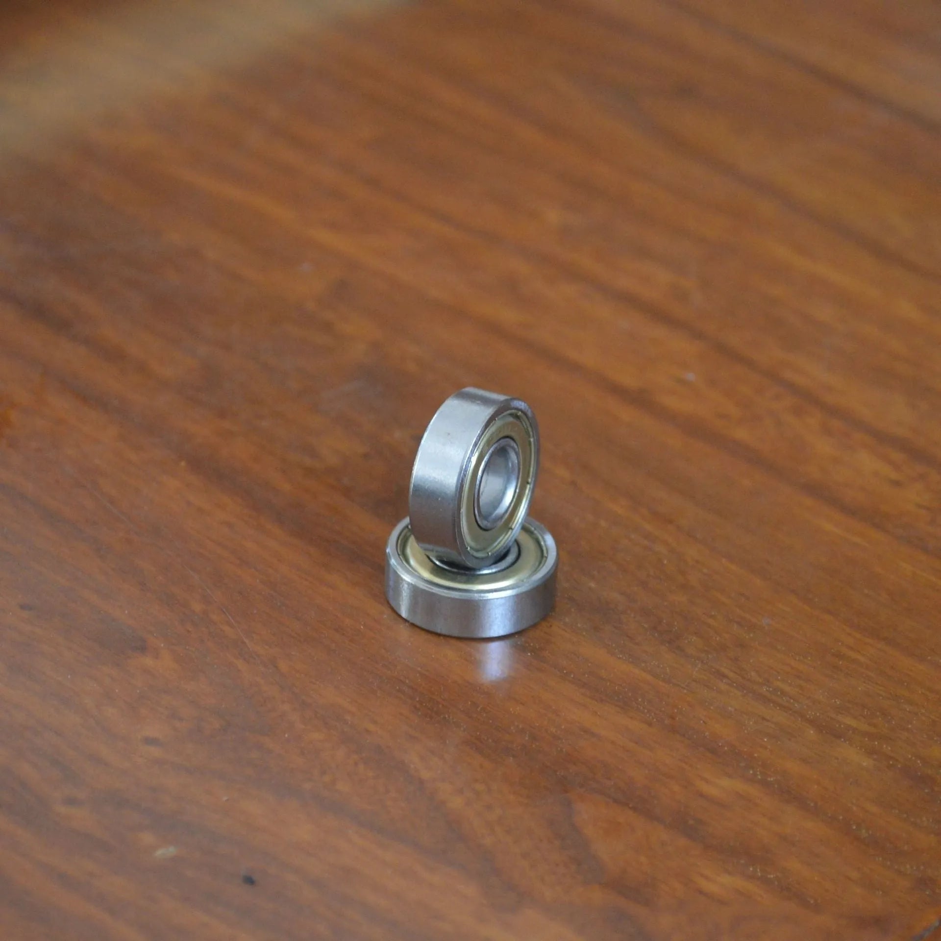Carbon steel bearing 6000zz 10x26x8mm with iron retainer on white background