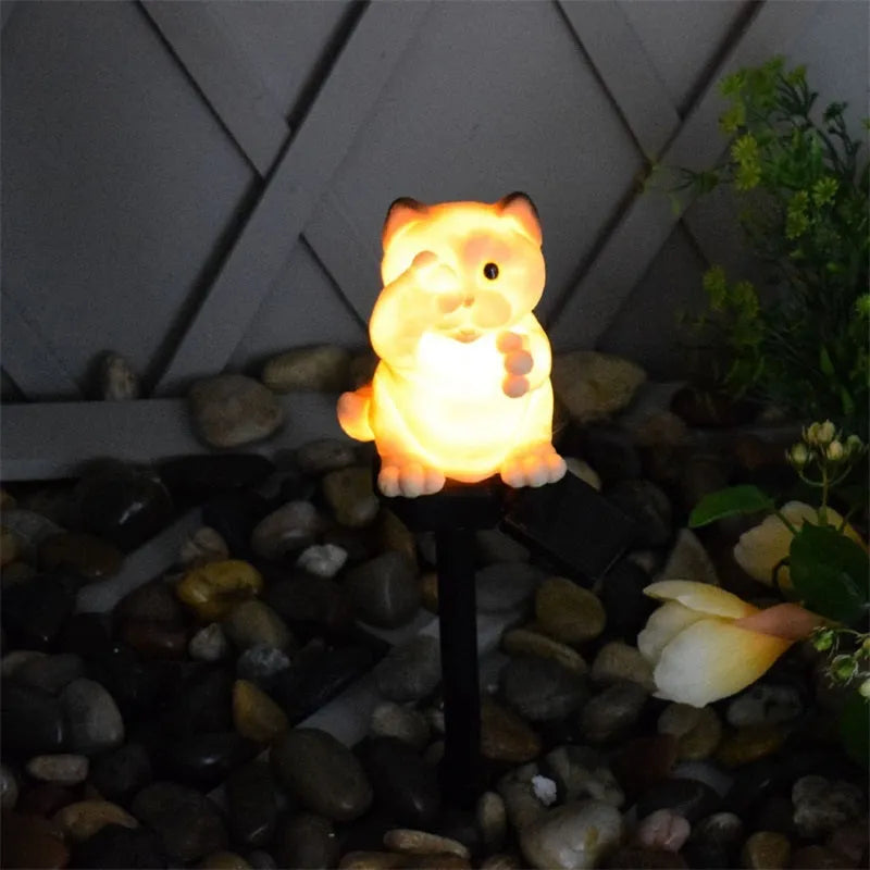 Brown cat-shaped solar-powered LED lawn light on grass