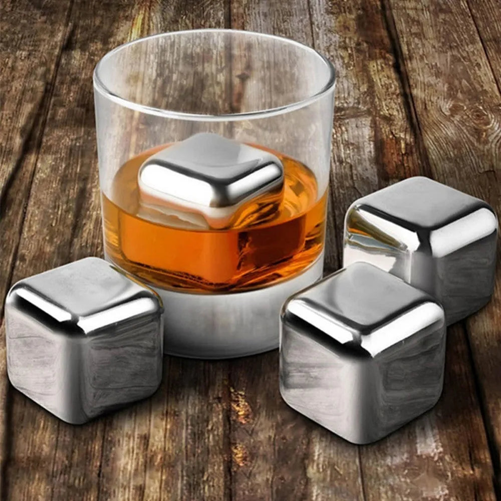 Set of 8 stainless steel ice cubes in square and ball shapes with plastic storage box and tong on a wooden surface