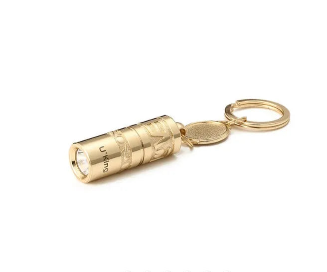 Gold-coloured zinc alloy waterproof mini LED keychain flashlight on a keyring.