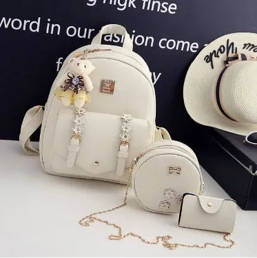 Three-piece women's bag set showing backpack, floral shoulder bag, and card holder in matching colour
