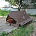 Brown or white A-line pole-free tent pitched with hiking canes showing 210x150x110cm dimensions