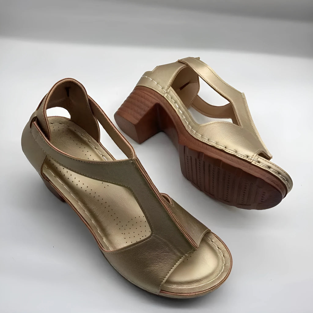 Women's beige peep toe wedge sandals with Roman ankle straps and a buckle closure on a low heel.