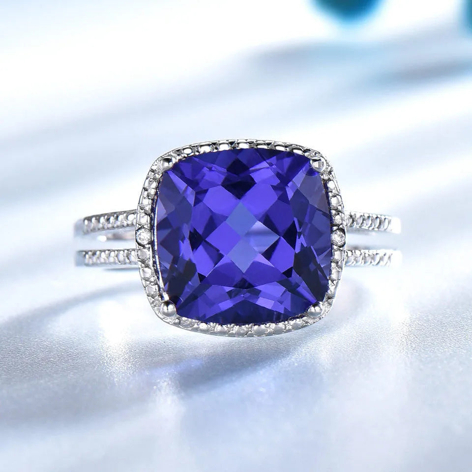 Blue Tanzanite gemstone set in a sterling silver women's ring on a white background.