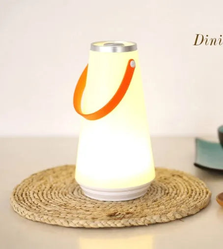 White LED rechargeable night light on a bedside table, 12x12x22cm ABS plastic body with warm glow