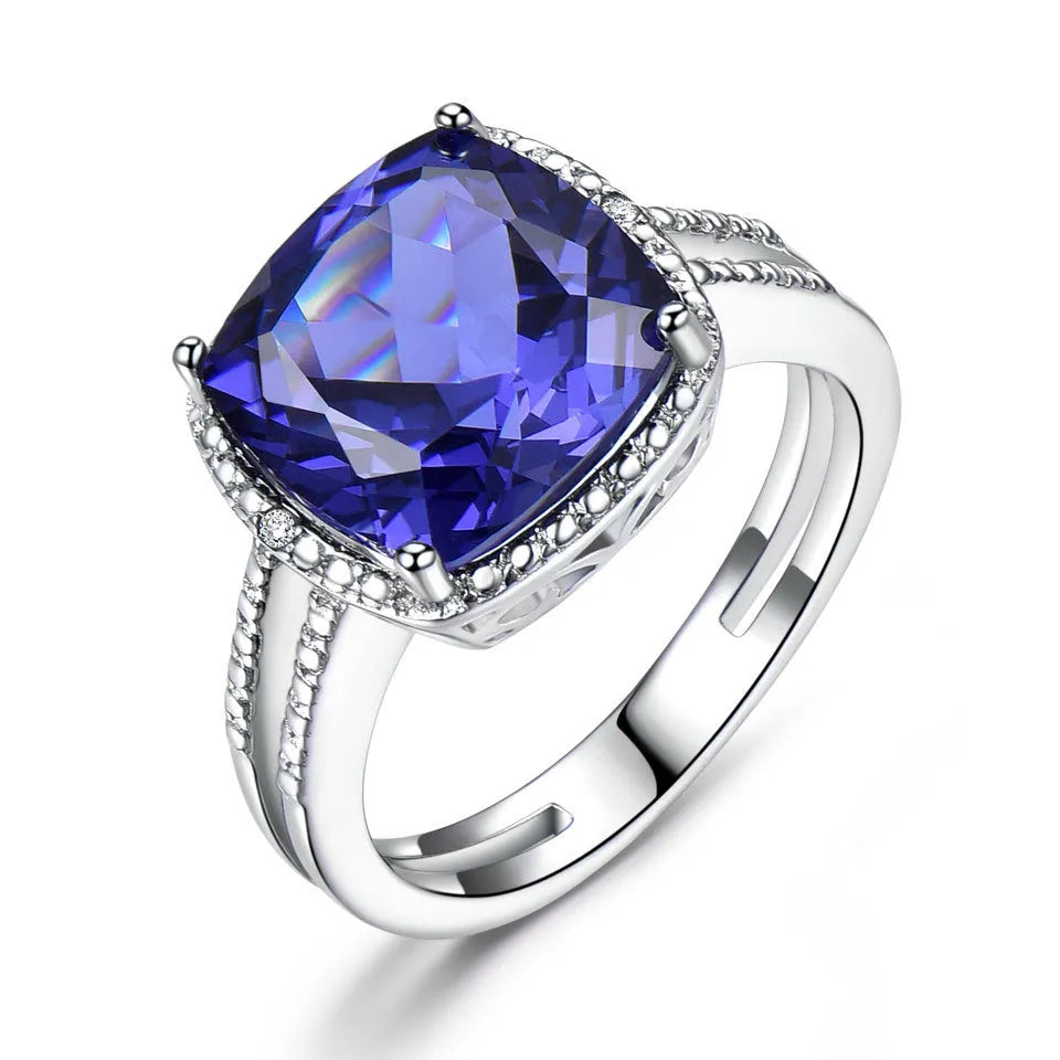 Blue Tanzanite gemstone set in a sterling silver women's ring on a white background.