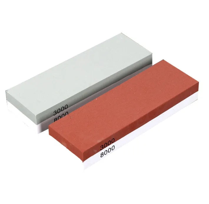 Double-sided white corundum kitchen whetstone 3000/8000 grit with bamboo base and knife holder locator on white background