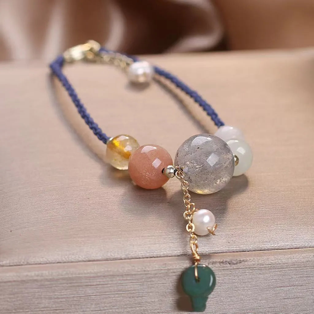 Hand-woven peace buckle bracelet with crystal and sequin details in red, green, and blue colour options for women