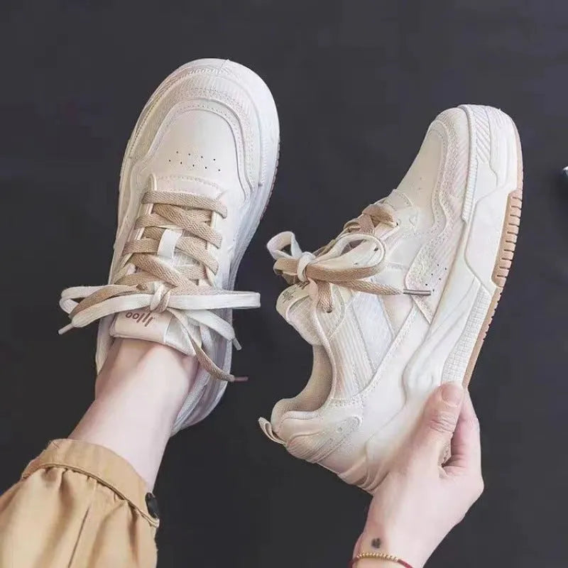 Women's pink low top sneaker with a rubber platform sole on a white background.