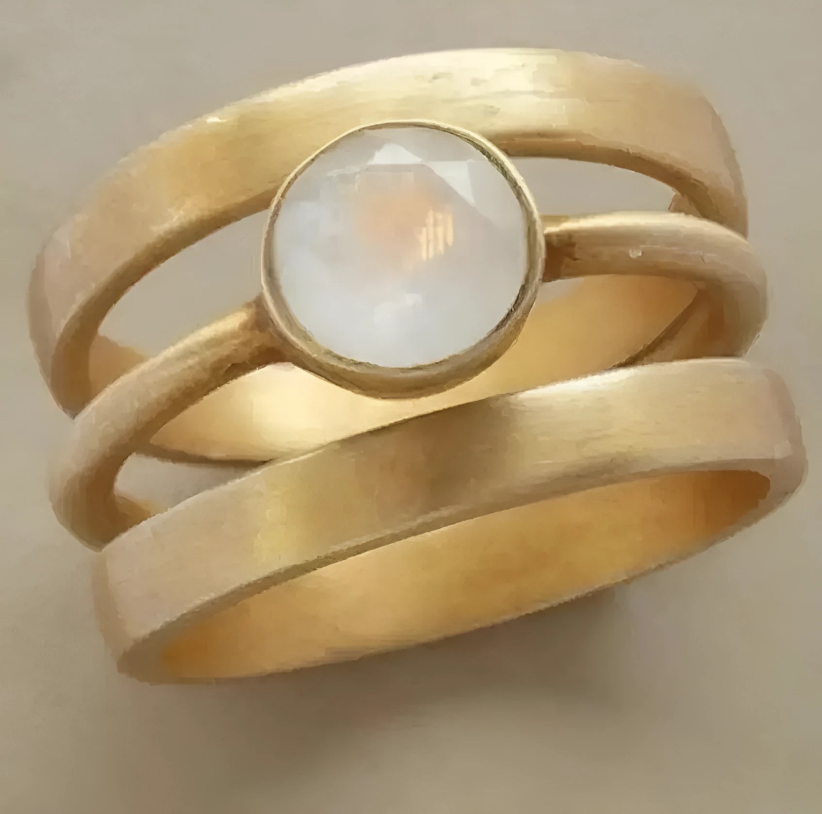 Gold-plated titanium steel ring with a hollow geometric design and micro-inlaid white chalcedony detail.