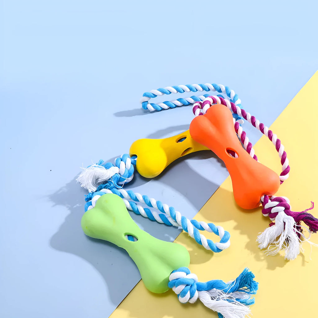 Red porous bone rope knot dog toy with treat-holding centre on white background
