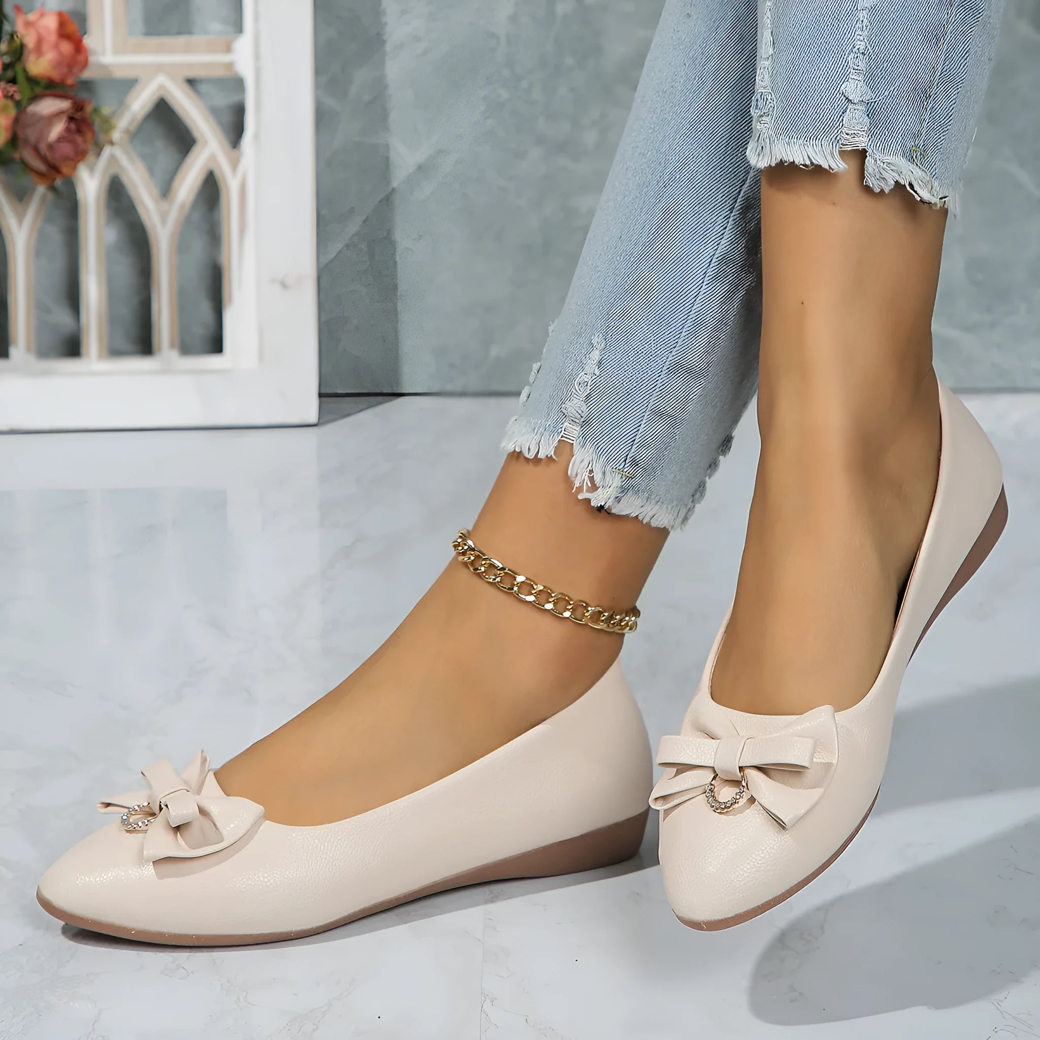 Women's beige casual flat loafers with a bowknot on the front, showing the shallow mouth and rubber sole.