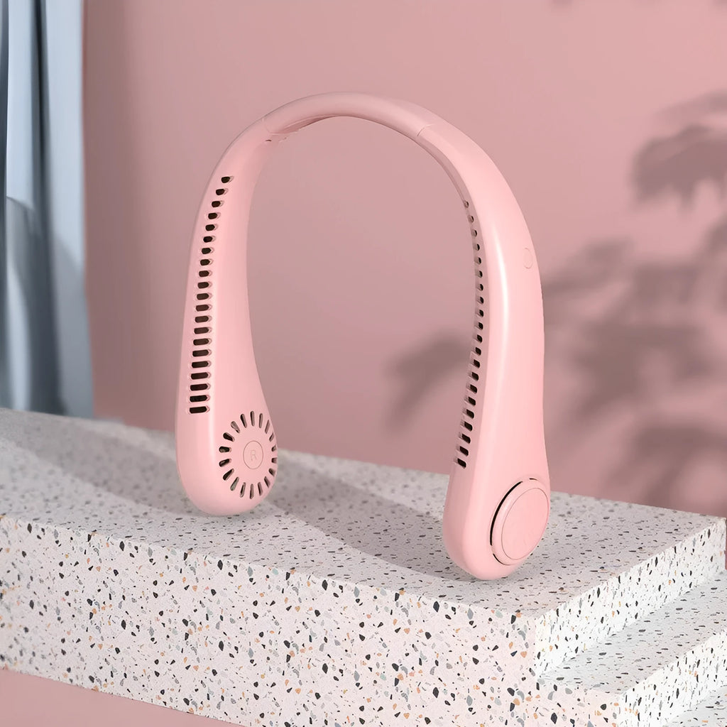 Pink portable bladeless neck fan being worn, showing USB charging port and control button.