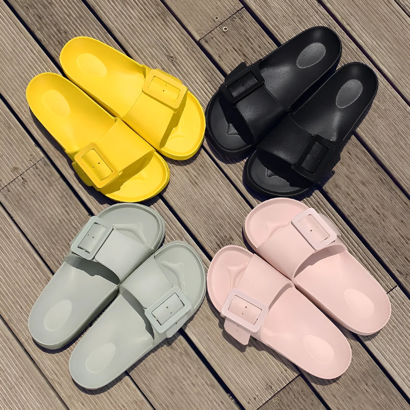 Women's grey blue buckle strap slippers with a soft EVA sole on a light background.